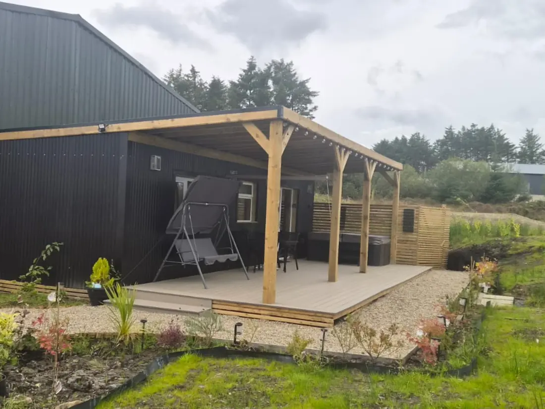 Spacious Family Lodge exterior with covered deck and countryside views