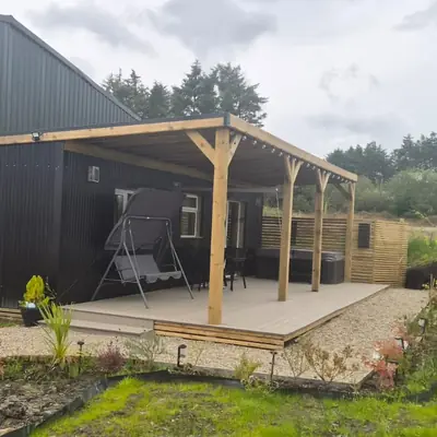 Spacious Family Lodge exterior with covered deck and countryside views
