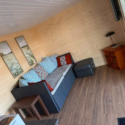 Living room with double sofa bed in the Spacious Family Lodge